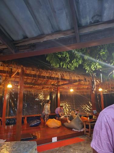 a group of people sitting on the floor of a hut at Tao Thong Villa 2 in Ko Tao