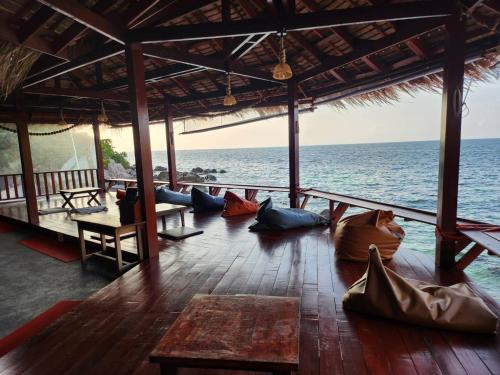 a group of people laying on the floor of a room overlooking the ocean at Tao Thong Villa 2 in Ko Tao