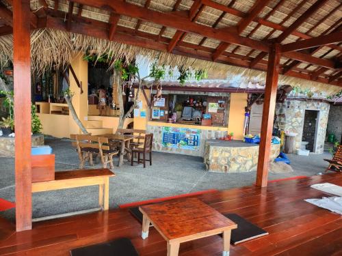 a living room with a table and a dining room at Tao Thong Villa 2 in Ko Tao