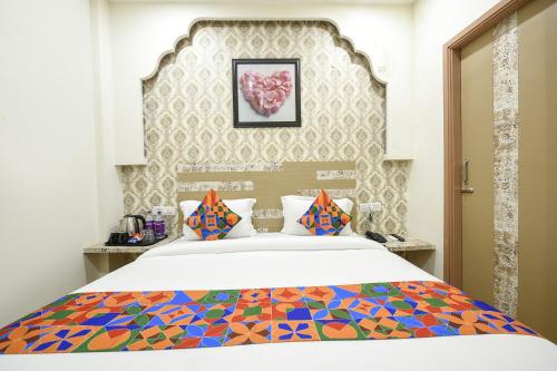 a bedroom with a bed with a colorful bedspread at FabHotel Nirvana Grand By IO in Amritsar