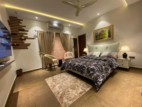 a bedroom with a bed and a television in it at Firefly Retreat-your home away from home in Rawalpindi