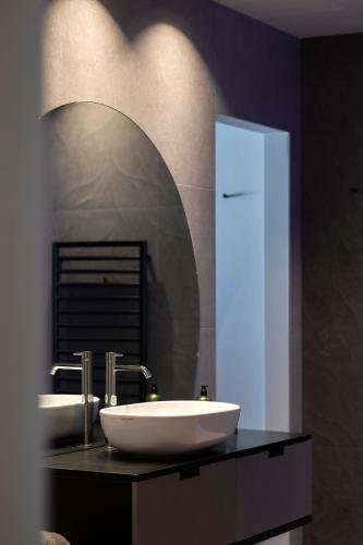 a bathroom with a white sink and a mirror at Hotel Viertler in Avelengo