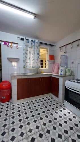 a kitchen with a black and white checkered floor at Furnished Homes Nakuru with pool & GYM in Nakuru