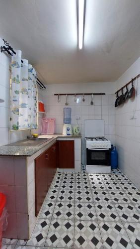 a kitchen with a black and white tiled floor at Furnished Homes Nakuru with pool & GYM in Nakuru