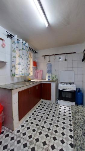 a kitchen with a black and white tiled floor at Furnished Homes Nakuru with pool & GYM in Nakuru