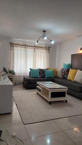 a living room with a couch and a coffee table at Furnished Homes Nakuru with pool & GYM in Nakuru