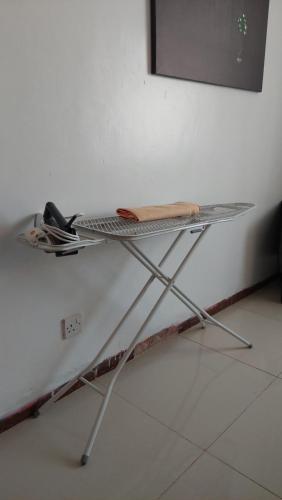 a metal table sitting on top of a white wall at Furnished Homes Nakuru with pool & GYM in Nakuru