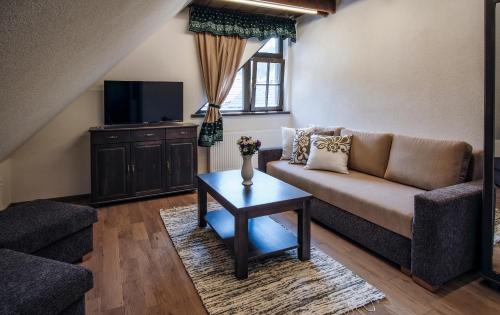 a living room with a couch and a table at Stará Zvonica in Nižná Boca