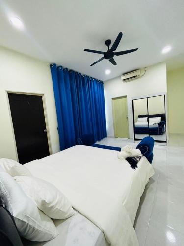 a bedroom with a large bed with a ceiling fan at Paddy View Homestay in Kangar