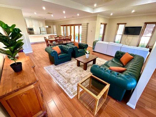 a large living room with a couch and a table at Grand retreat in peaceful street in Wodonga