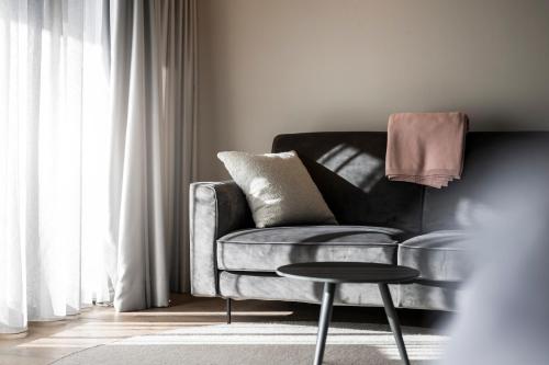 a living room with a couch and a table at Hotel Viertler in Avelengo