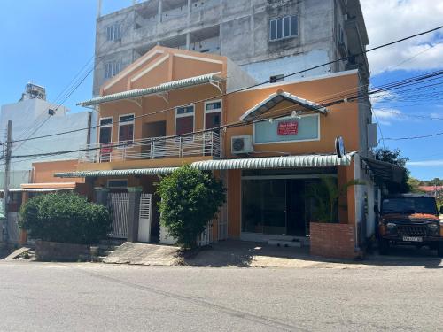 an orange building with a sign in front of it at Tony's Homestay in Ấp Thiện Phước