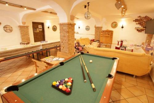 a billiard table in a living room with at Wolfeicherhof in Eggstätt