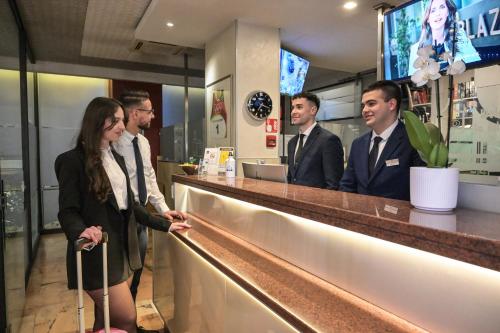 a group of people standing at a bar at Hotel Plaza in Turin