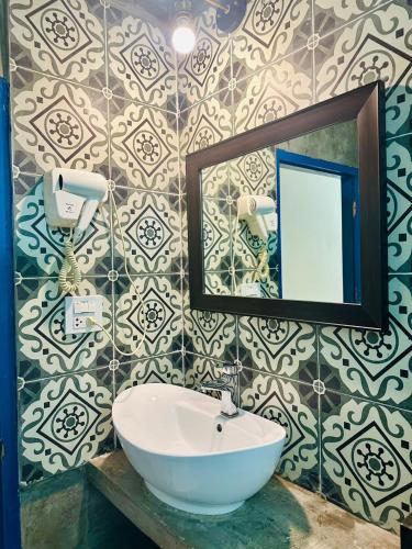 a bathroom with a sink and a mirror at Zen Boutique House in Luang Prabang