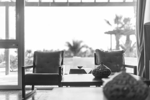 a living room with two chairs and a table at El Gouna Elite Worldwide Sea & Garden Residences - Hurghada, Egypt in Hurghada