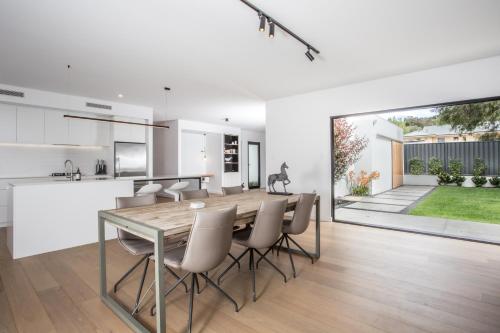 a kitchen and dining room with a table and chairs at Bluff Street Home by the BnB Collection in Albany