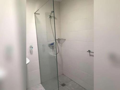 a bathroom with a glass shower with a sink at Charming 3 bedroom villa located in Moraira. in Teulada