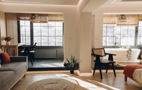 a living room with a couch and a tub at Great Exodus - Iasi City Center in Iaşi