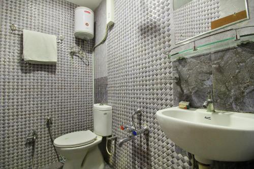 a bathroom with a toilet and a sink at OYO The Park Royal in Chennai