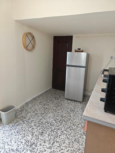 a kitchen with a refrigerator in the corner of a room at Limnitis Traditional House in Limnitis