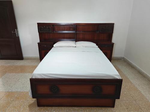 a wooden bed with two pillows on top of it at Limnitis Traditional House in Limnitis