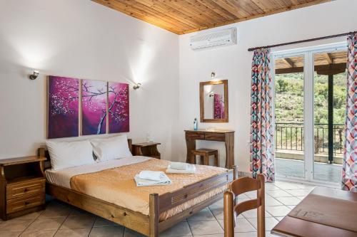 a bedroom with a bed in a room with a window at Rania Apartments in Agios Nikitas