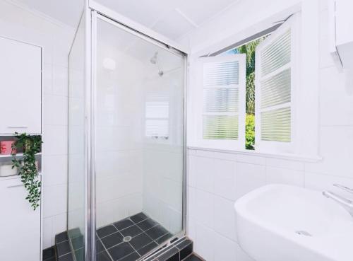 a bathroom with a glass shower and a toilet at UrbanNook - Heart of the city in Brisbane