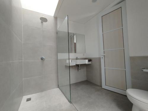 ウルワツにあるRumah Menikのバスルーム(シャワー、洗面台、トイレ付)