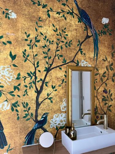 a bathroom with a tree mural on the wall at BEAUTIFUL APARTMENT WiTH ASIAN STYLE BEDROOM NEAR RAI & CENTER in Amsterdam