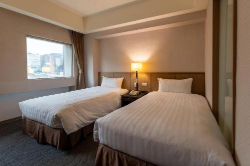 Postel nebo postele na pokoji v ubytování Guide Hotel Taipei Chongqing