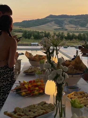 a table with a buffet of food on it at Agriturismo Colle Igino in Matera