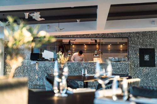 a man standing in the kitchen of a restaurant at Gennadi Grand Resort in Gennadi