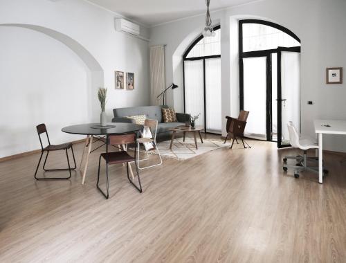 a living room with a table and chairs and a couch at ComeCasa Bright City Flat with Private Terrace in Milan