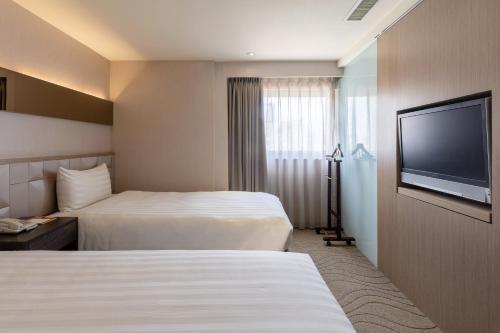 Postel nebo postele na pokoji v ubytování Guide Hotel Taipei Chongqing