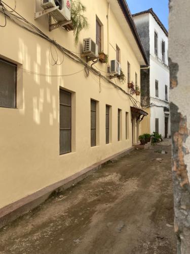 an empty street in an alley between two buildings at Caravan Serai Amour in Stone Town