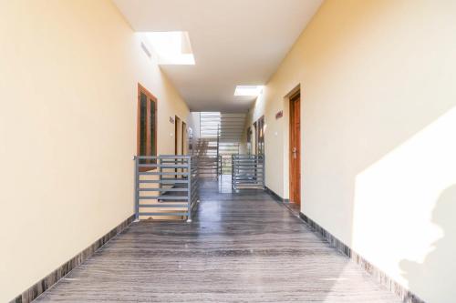 a corridor of an empty building with stairs at Liberty Apartments in Chakkarakkal