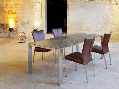 a dining table with four chairs and a concrete table at Test Tet Qa Kari in Munich