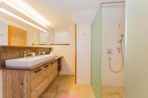 a bathroom with a sink and a shower at Holiday Home Hettlerhof in Maishofen