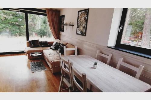 un salon avec une table et un canapé dans l'établissement Le Chamroussien - Appartement 1700, à Chamrousse