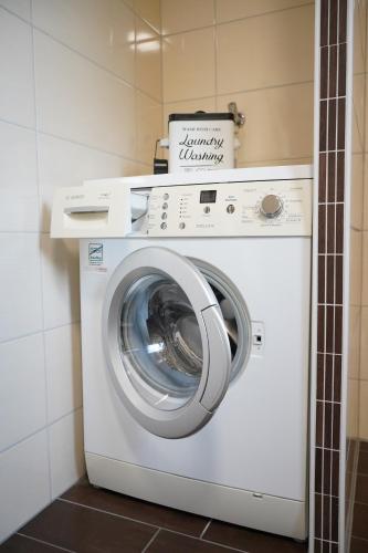 a washing machine with a box on top of it at PureNature Appartement in Obersontheim