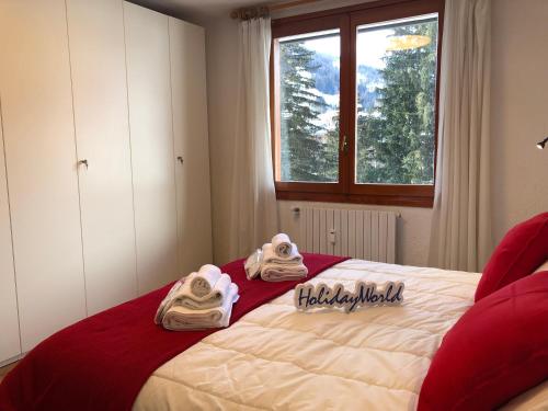 a bedroom with a bed with towels on it at House Edelweiss by Holiday World in La Thuile