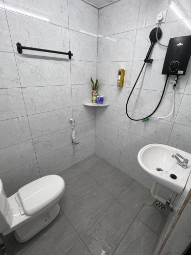 a bathroom with a toilet and a sink at Agro Village Stay in Tapah