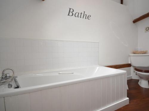 a white bath tub in a bathroom with a toilet at 1 Bed in Tunbridge Wells 43355 