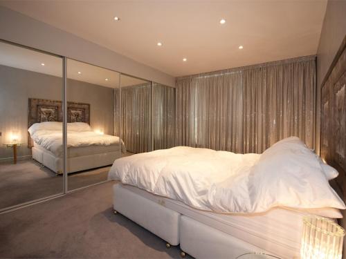 a bedroom with two beds and a large mirror at 2 Bed in Harrogate HH073 in Harrogate