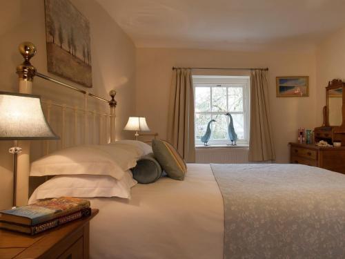 a bedroom with a bed and a window with birds at 2 Bed in Cartmel LCC75 in Cartmel