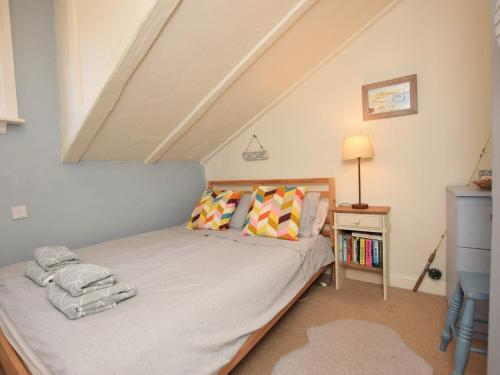 a small bedroom with a bed in a attic at 2 Bed in Dunstan CN031 in Craster