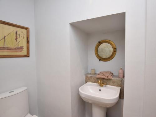 a bathroom with a white toilet and a sink at 2 Bed in Dunstan CN031 in Craster