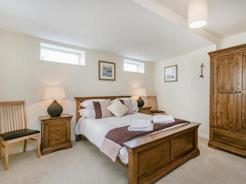 a bedroom with a large bed and two night stands at 4 Bed in Brixham BX072 in Brixham