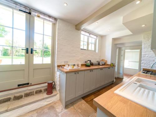 a kitchen with a sink and a large window at 4 Bed in Isle of Purbeck IC177 in Corfe Castle